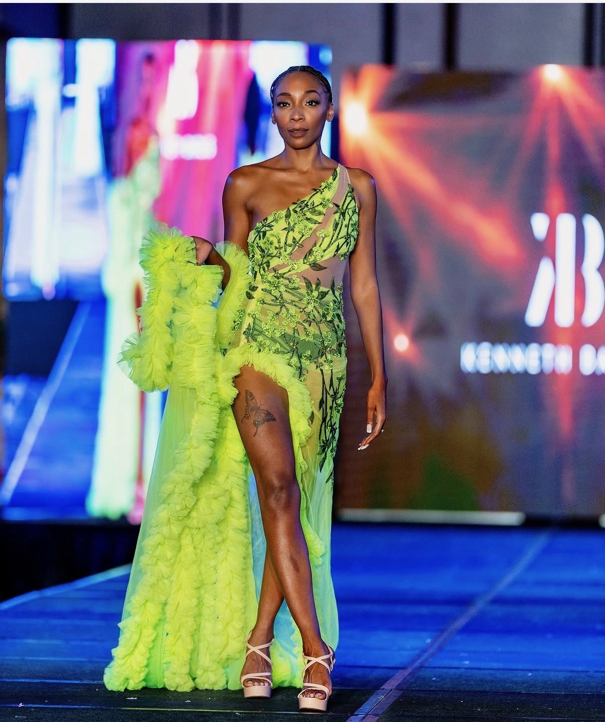 Amari Kelley walking a neon couture gown on the runway